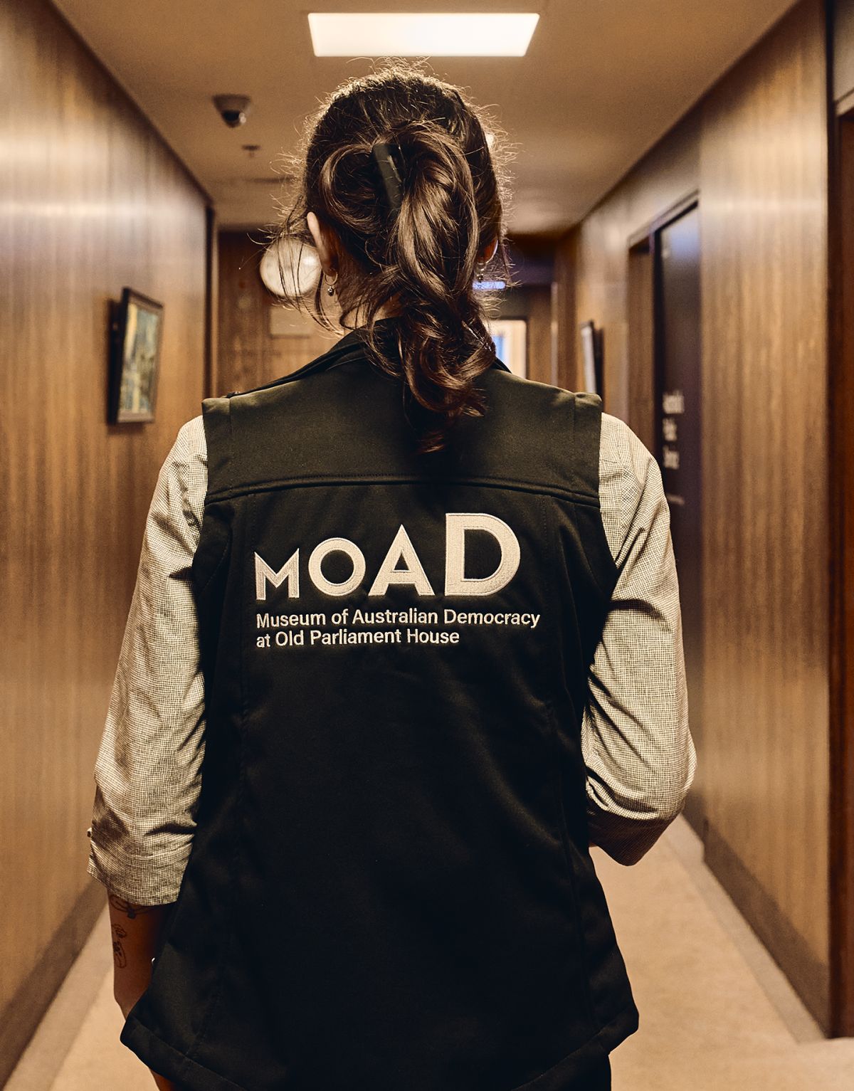 MoAD staff vest with logo on female staff member